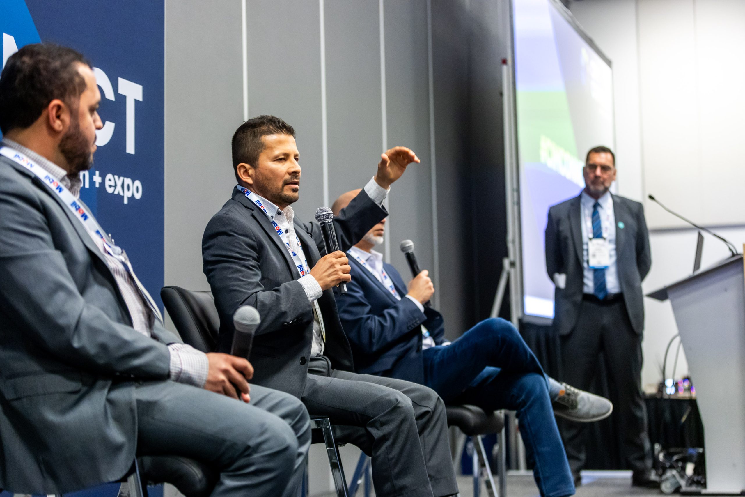 Panelists speaking during a conference session