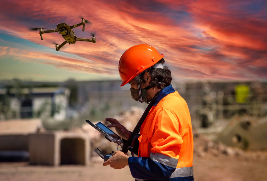 Miner in safety gear operating a drone